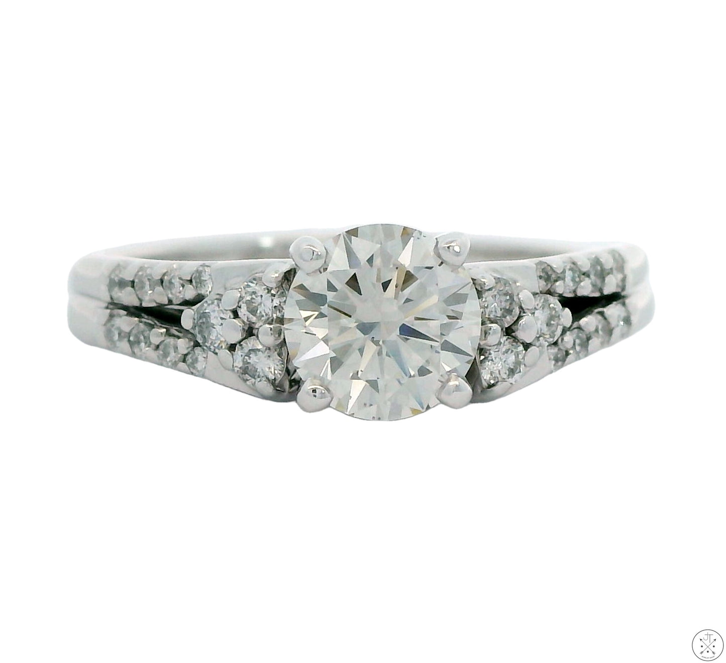 A 14k white gold engagement ring featuring a lab grown diamond center stone with smaller diamonds in the guard, size 9.25.