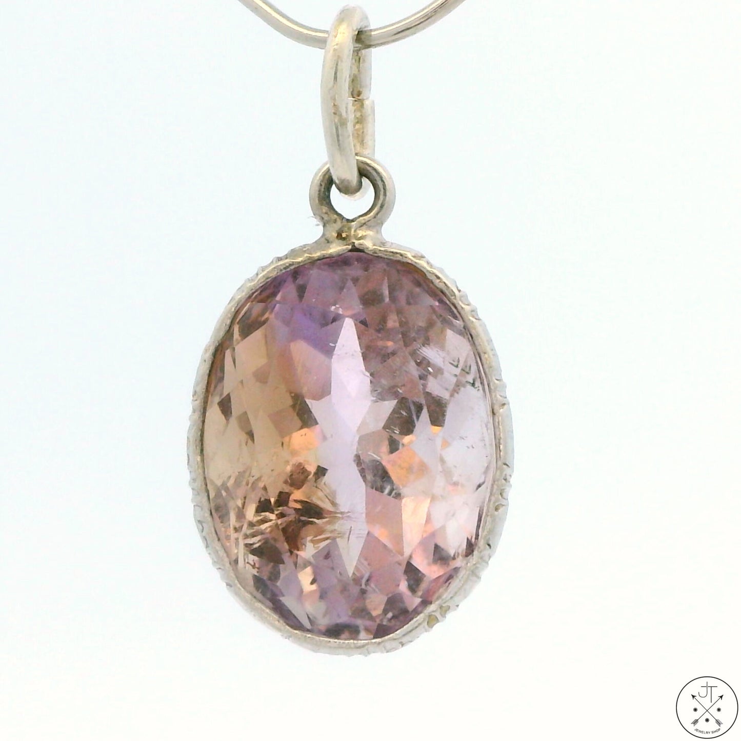 A sterling silver bezel set oval ametrine pendant.