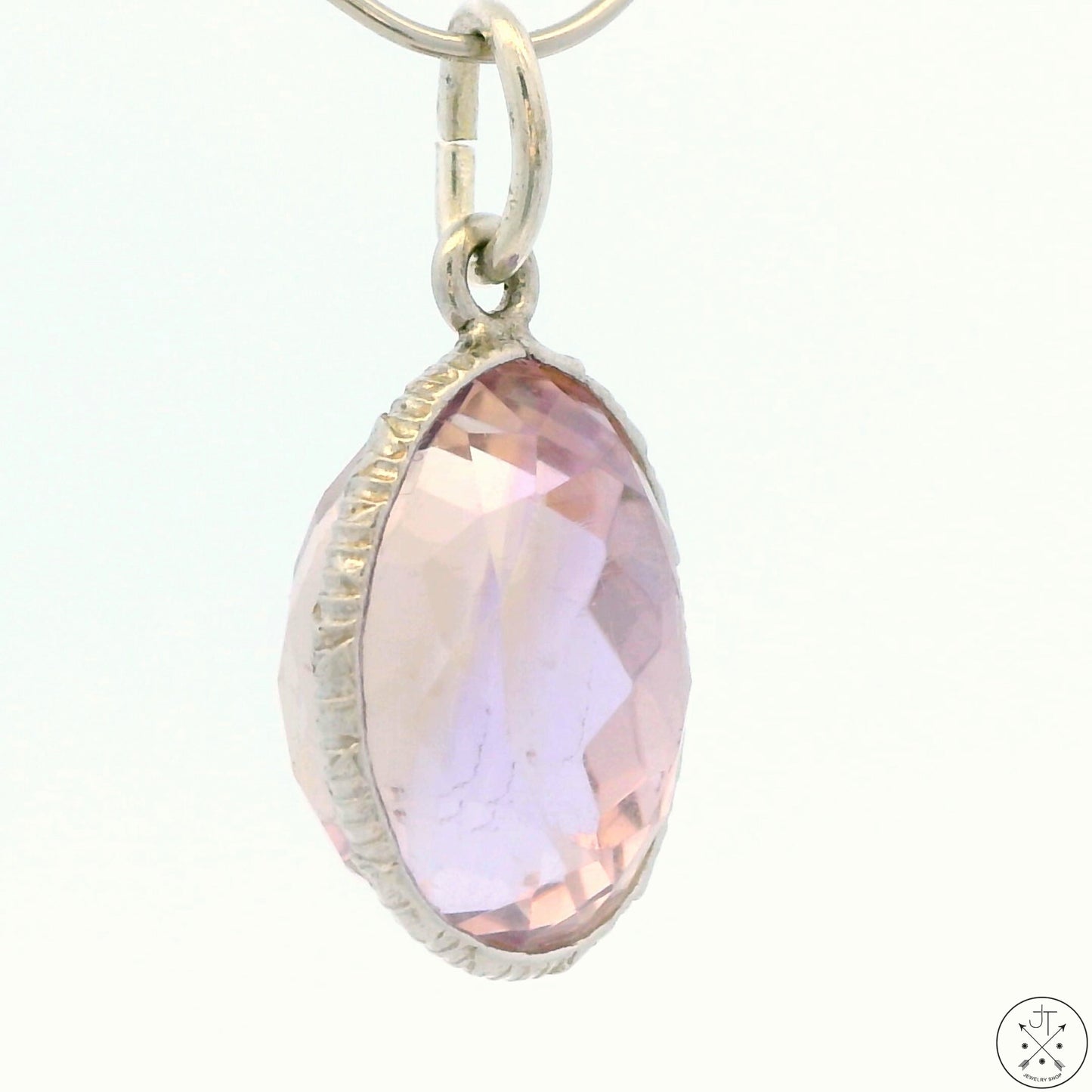 A sterling silver bezel set oval ametrine pendant.
