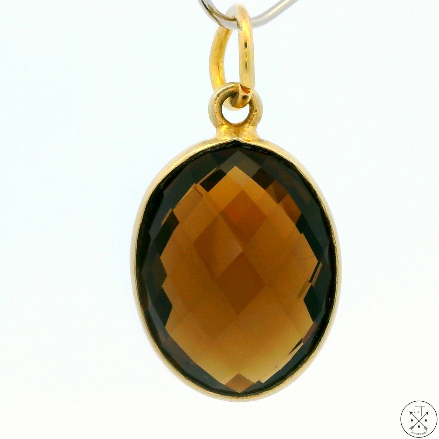 A gold-tone sterling silver bezel-set oval smoky quartz pendant.