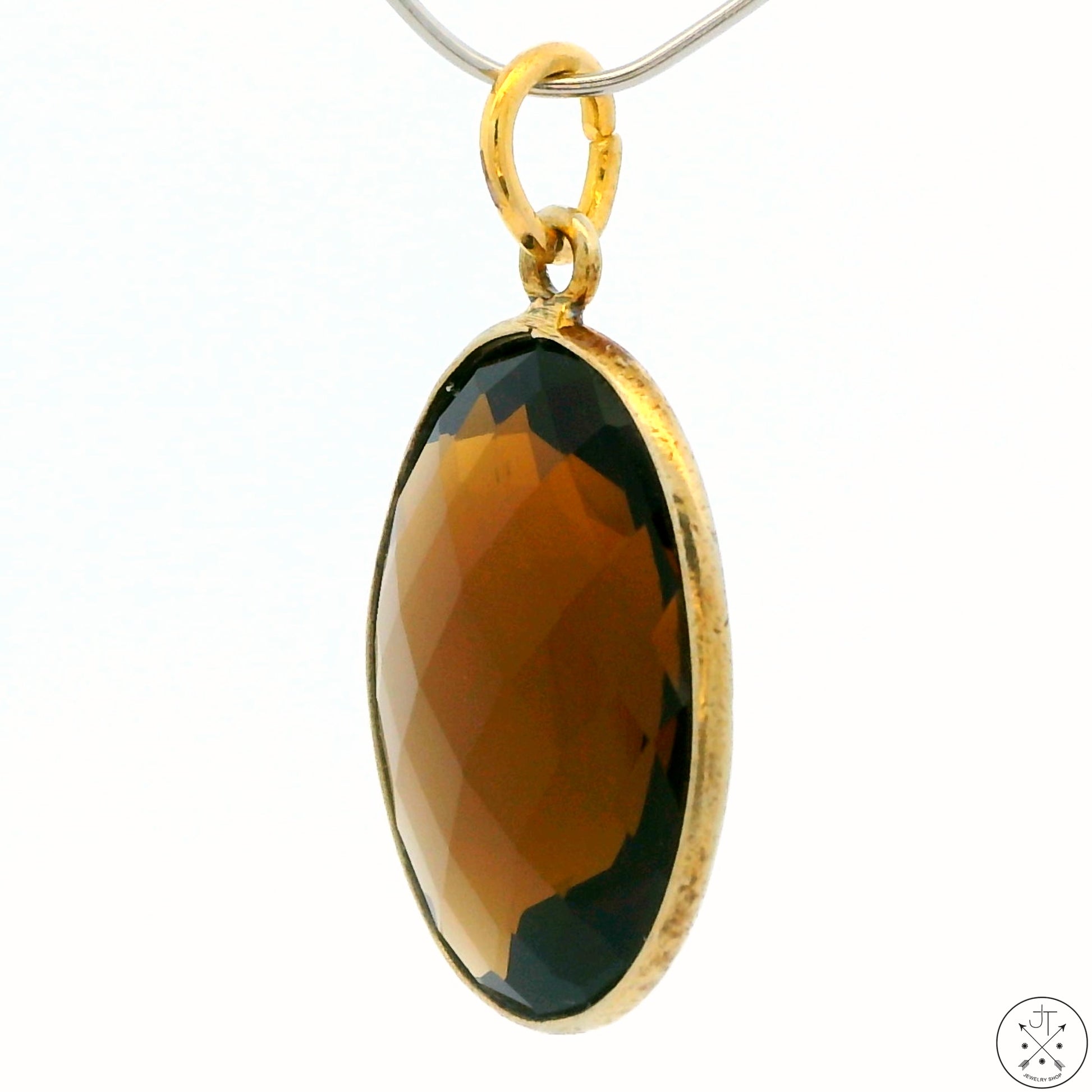 A gold-tone sterling silver bezel-set oval smoky quartz pendant.