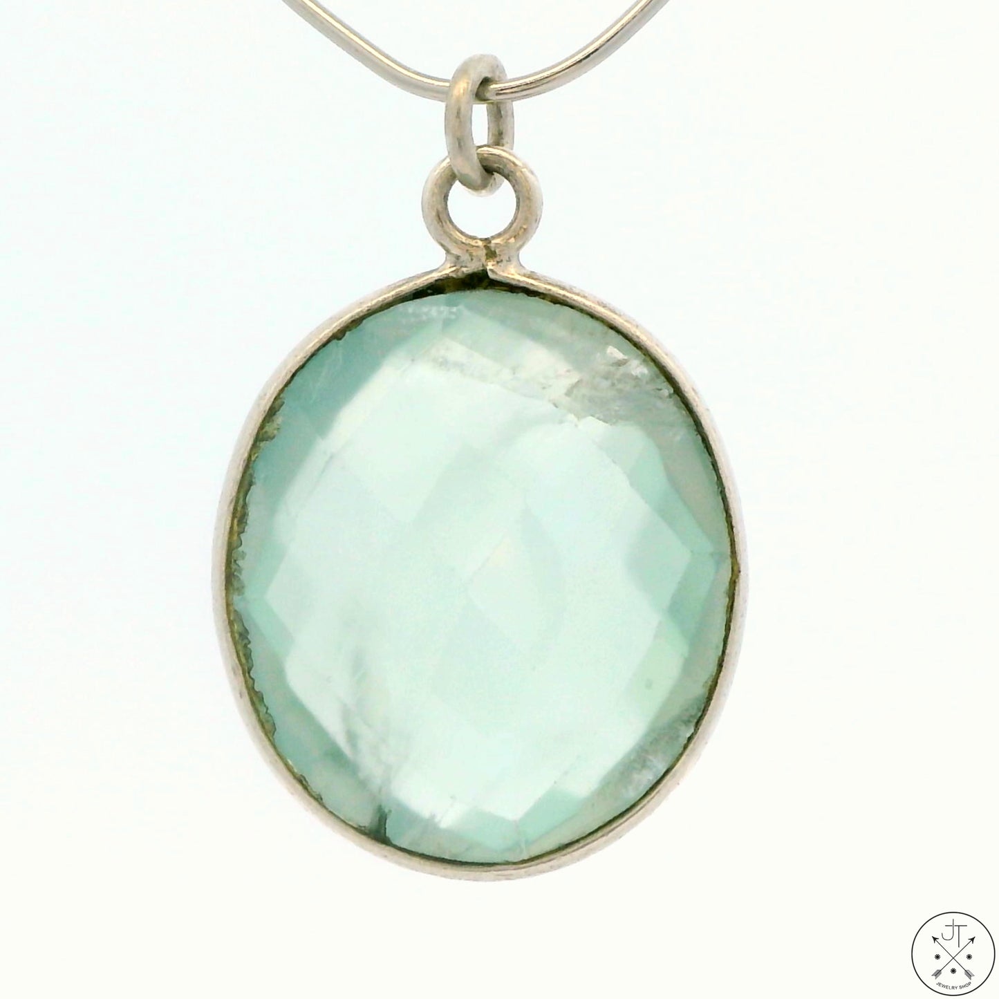 A sterling silver bezel-set oval green quartz pendant.