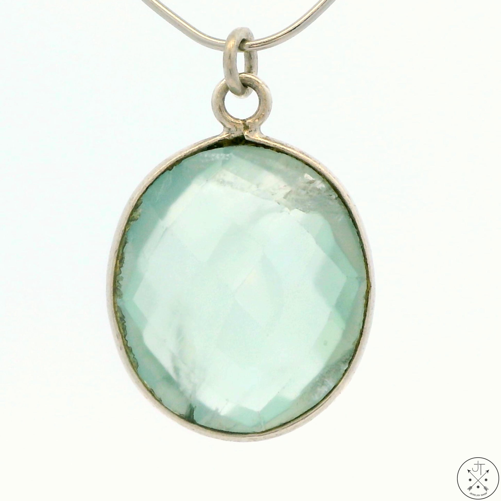 A sterling silver bezel-set oval green quartz pendant.