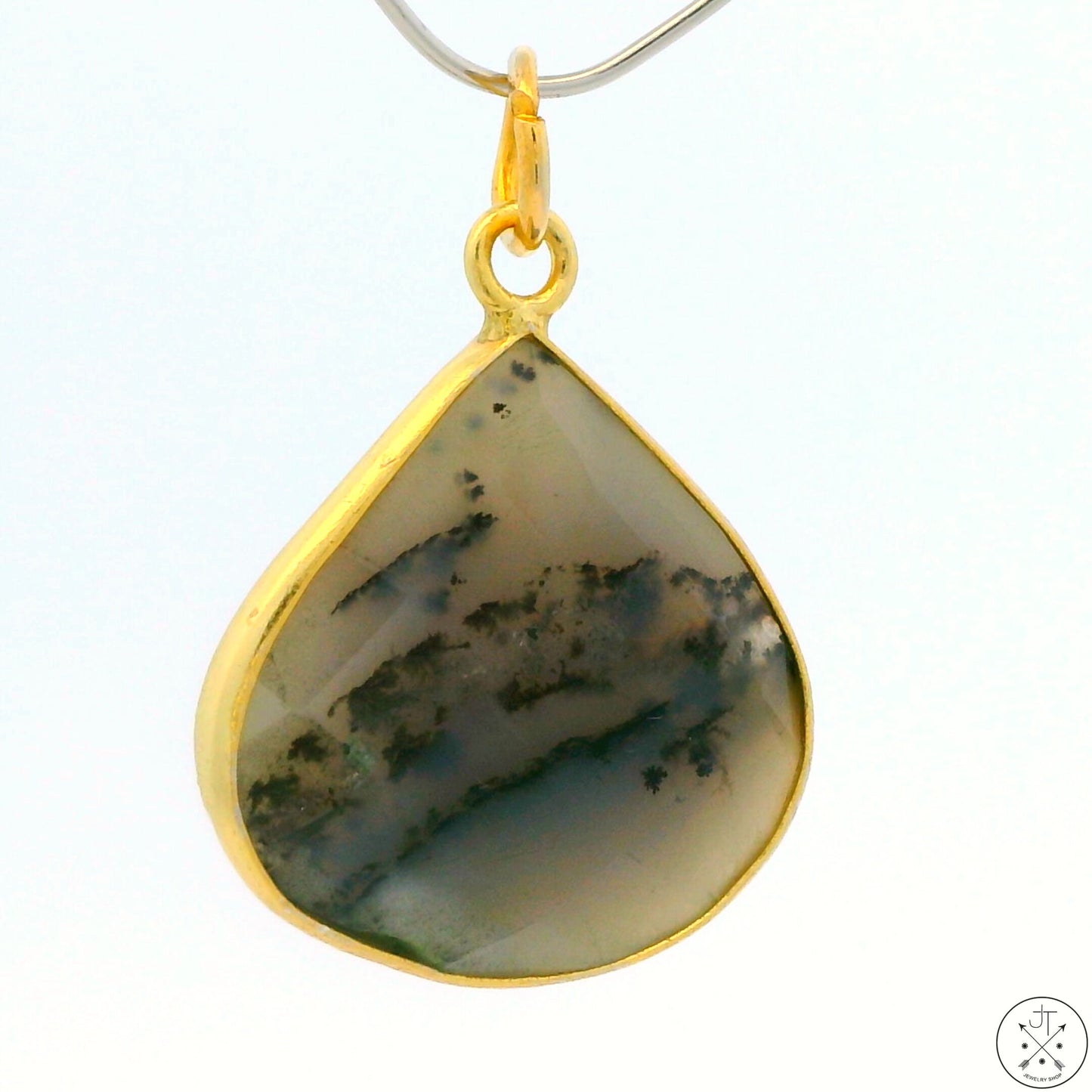 A gold-toned sterling silver bezel-set moss agate pendant.