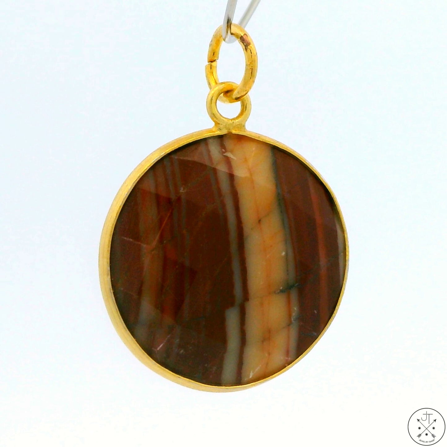 A gold-tone sterling silver bezel-set striped agate pendant.