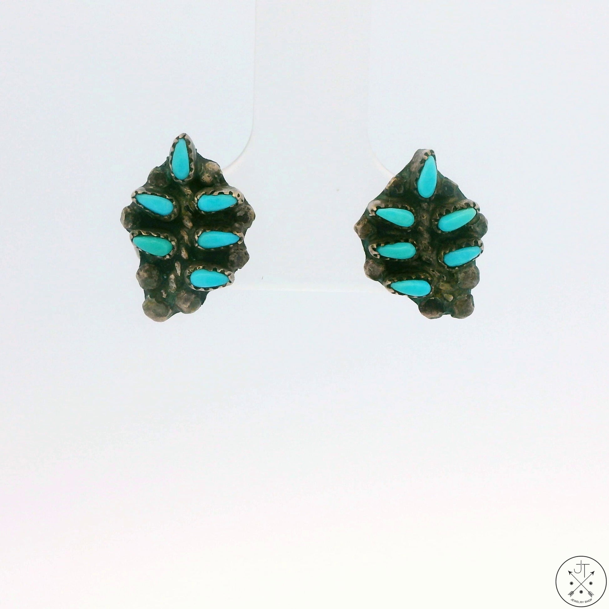 A pair of vintage sterling silver stud earrings with turquoise palm frond design, displayed against a white background.