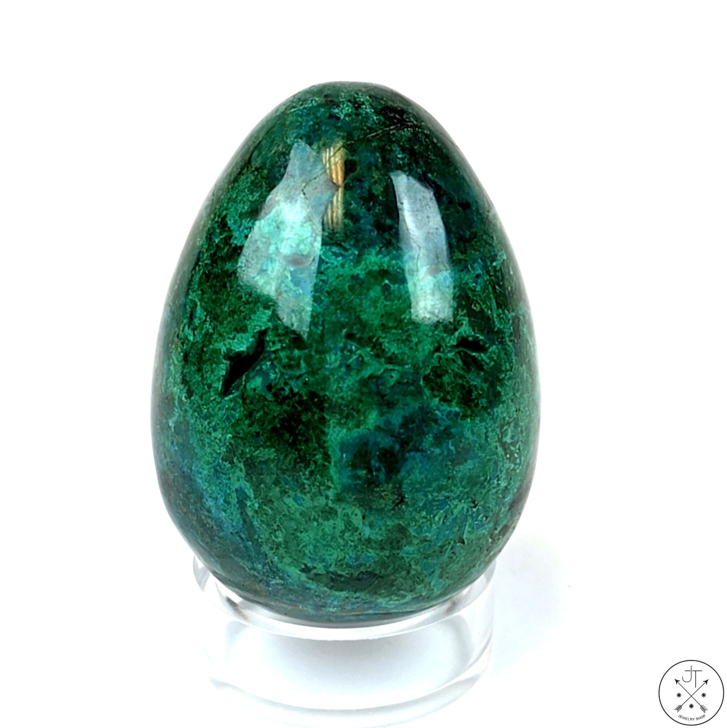 A polished, vibrant green Chrysocolla gemstone egg with a smooth surface, displayed on a clear stand.