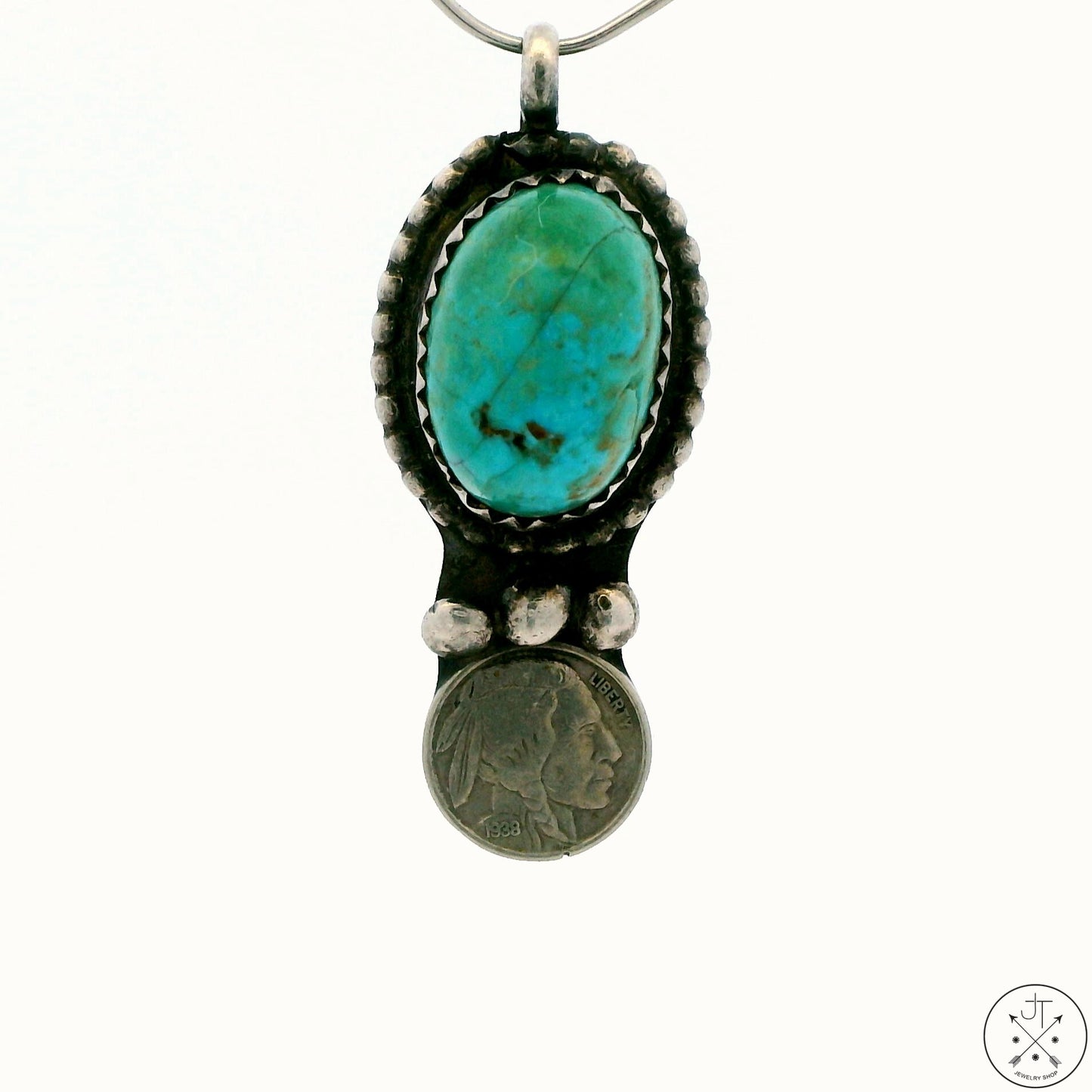 A Sterling Silver pendant with a high domed turquoise cabochon and a silver Indian-head nickle copy, etched with 'WB 1983'.
