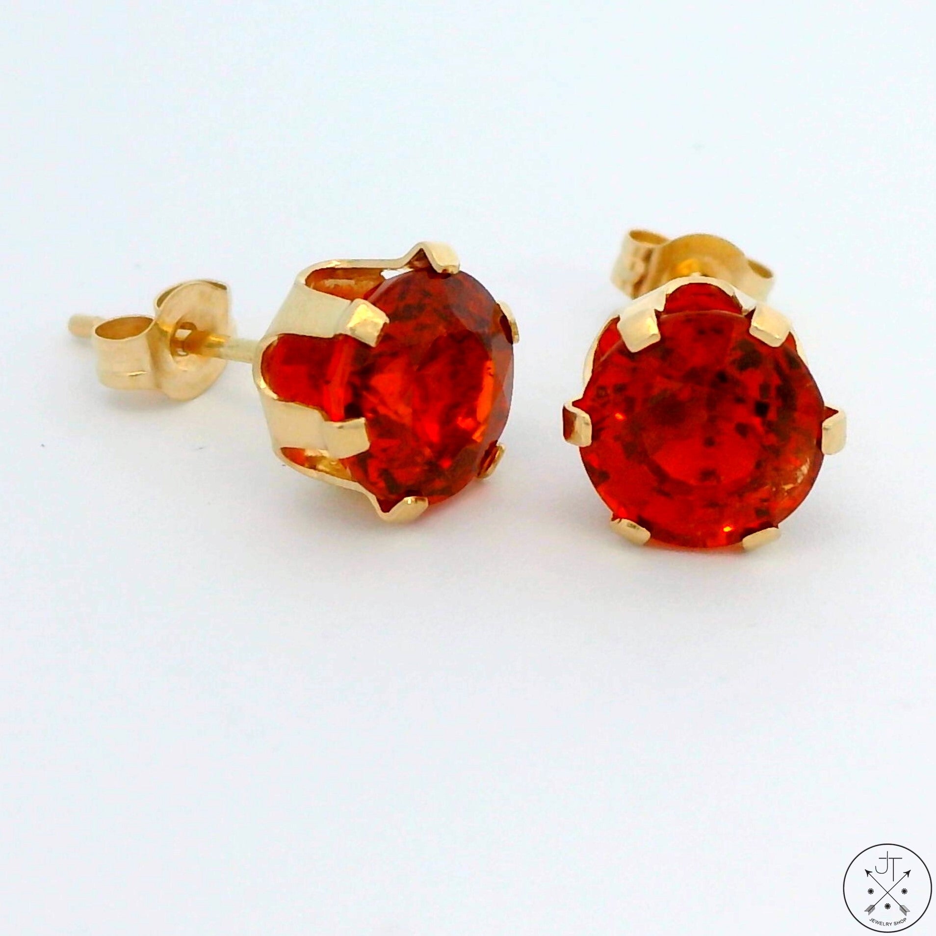 A pair of 14k yellow gold stud earrings with 2.7 ctw citrine 6.6 mm in diameter, with butterfly backs.