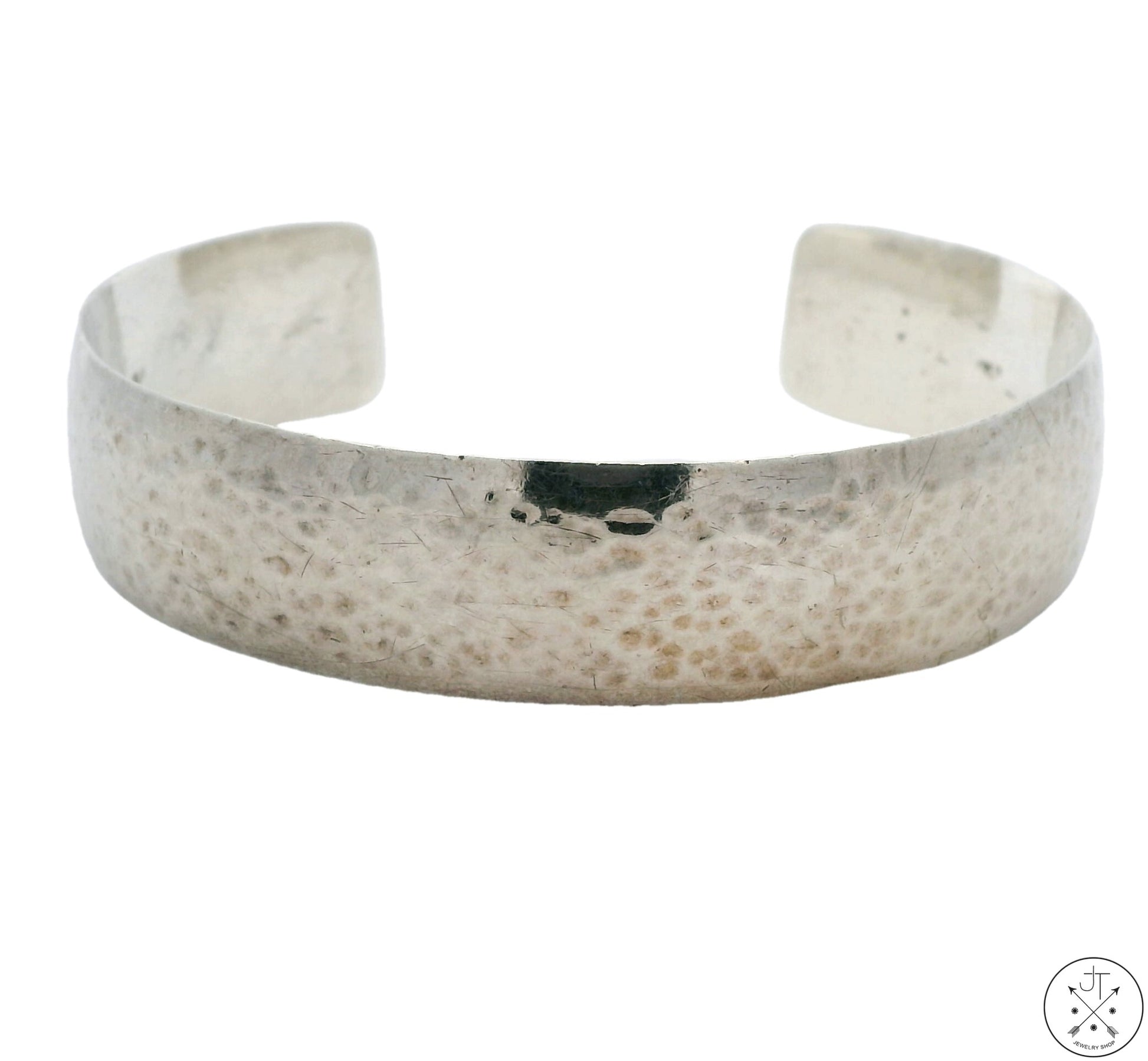 A vintage hammered sterling silver cuff bracelet with a brutalist finish, showing signs of wear but not polished.