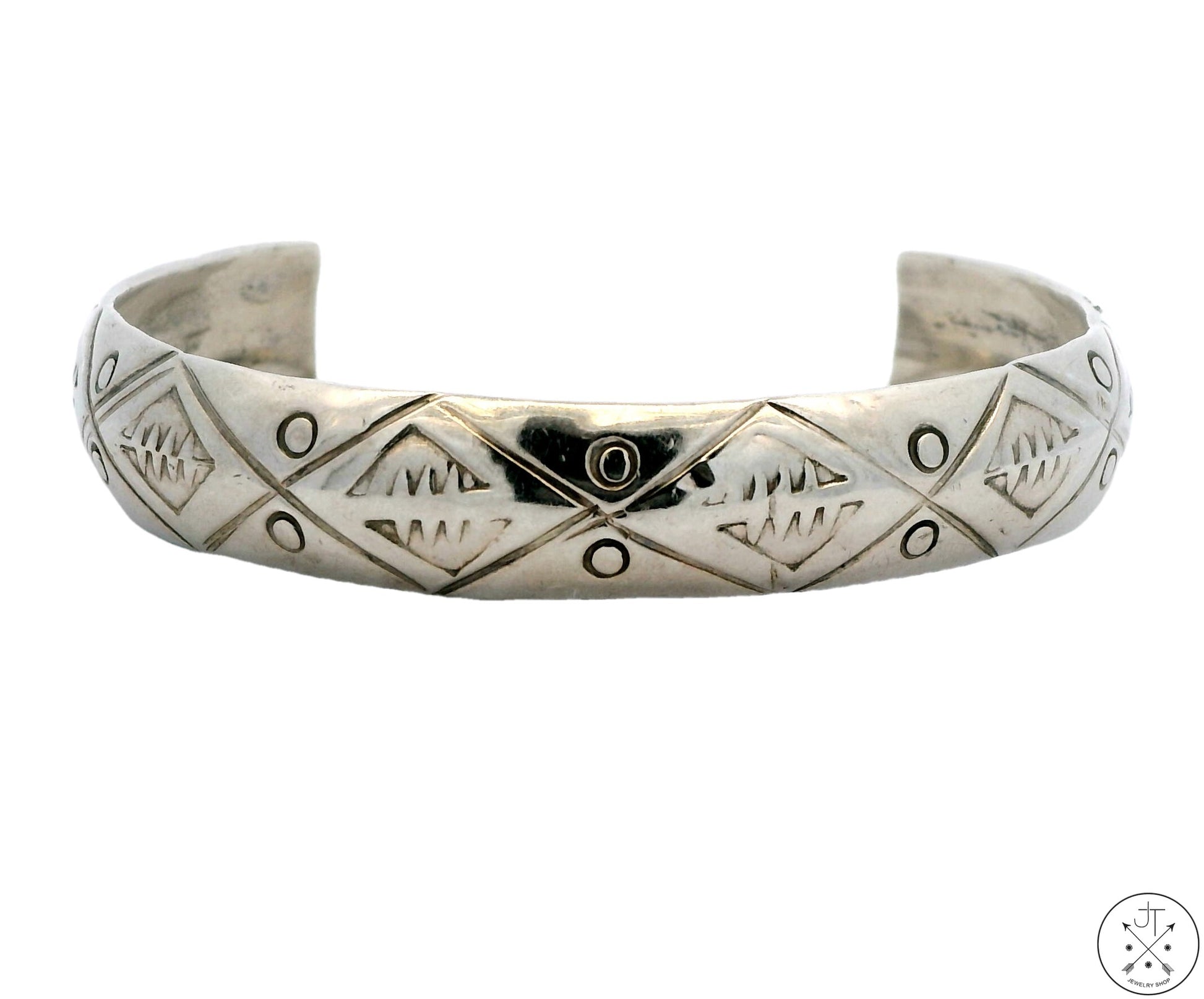 A vintage Native American sterling silver domed cuff bracelet with geometric patterning and a Native American profile mark.