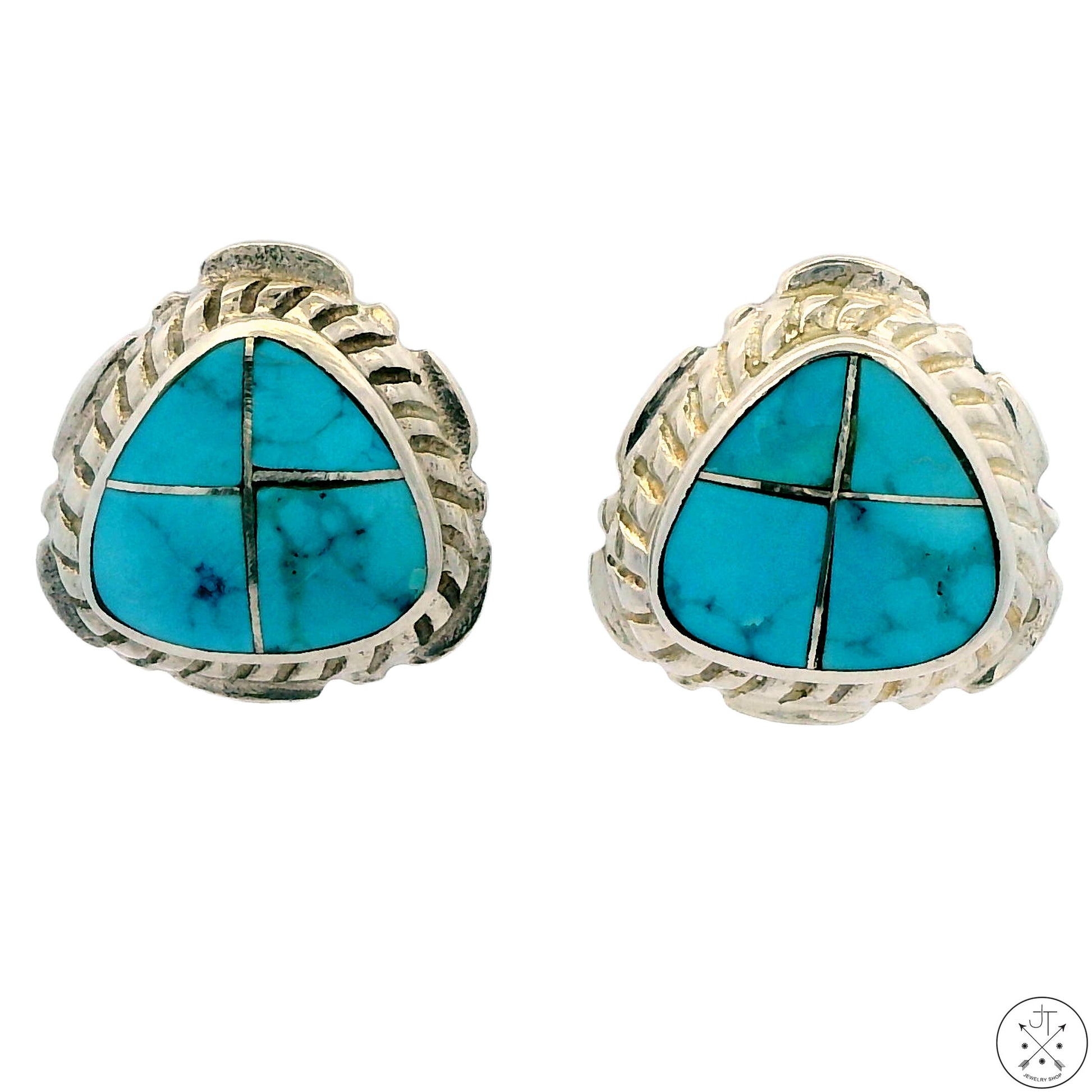 A pair of sterling silver stud earrings featuring a turquoise inlay design with geometric patterns, signed by Lucas.