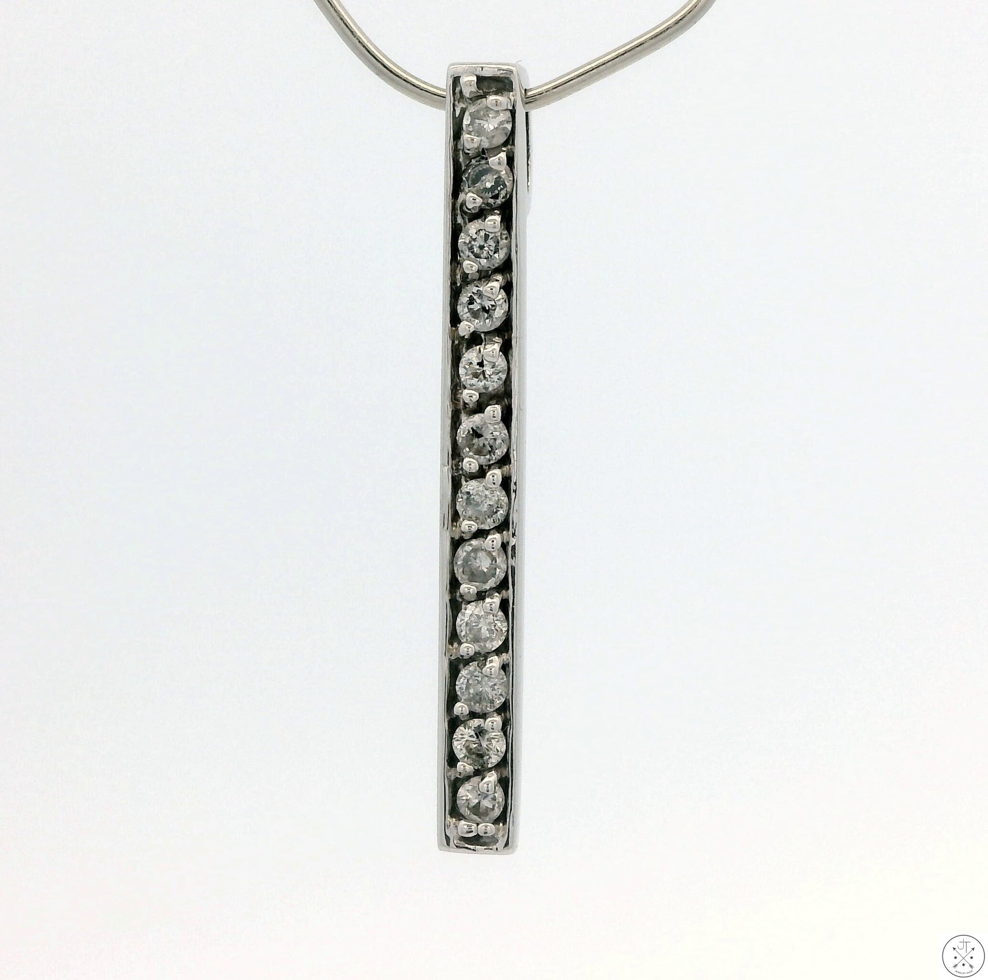 A vertical bar-style 14k white gold pendant with natural diamonds embedded along its length, displayed against a white background.