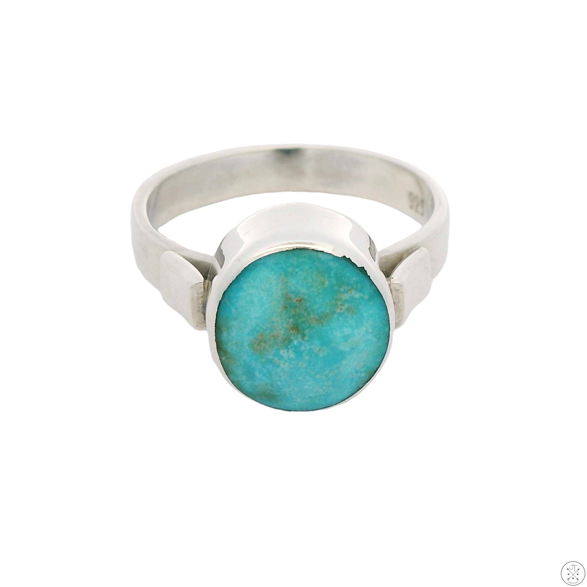 A sterling silver ring with a round cabochon of natural turquoise from the Cripple Creek mine, featuring a sleek modernist design.