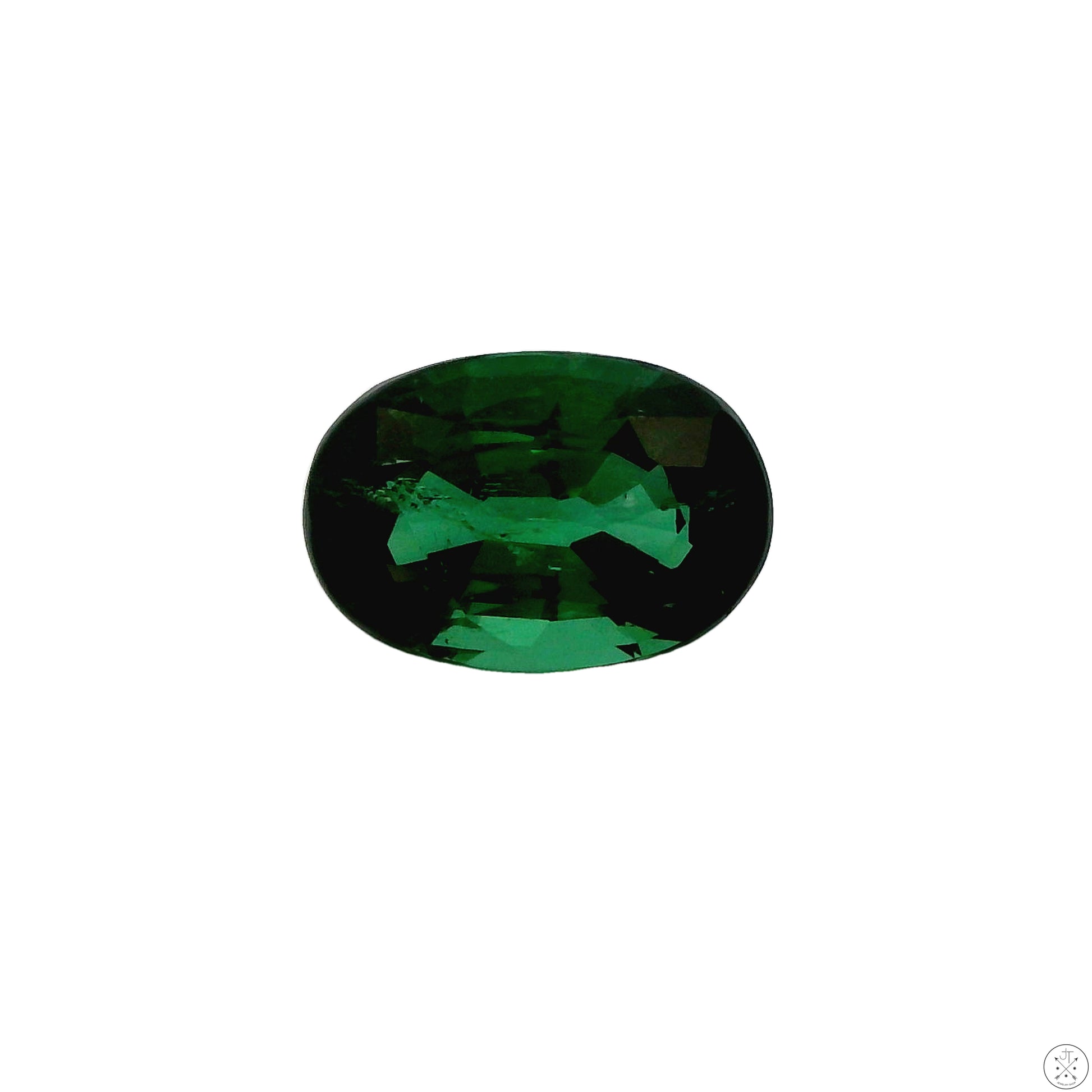 A loose oval faceted Tsavorite Garnet gemstone with a green hue, slightly included, displayed against a white background.