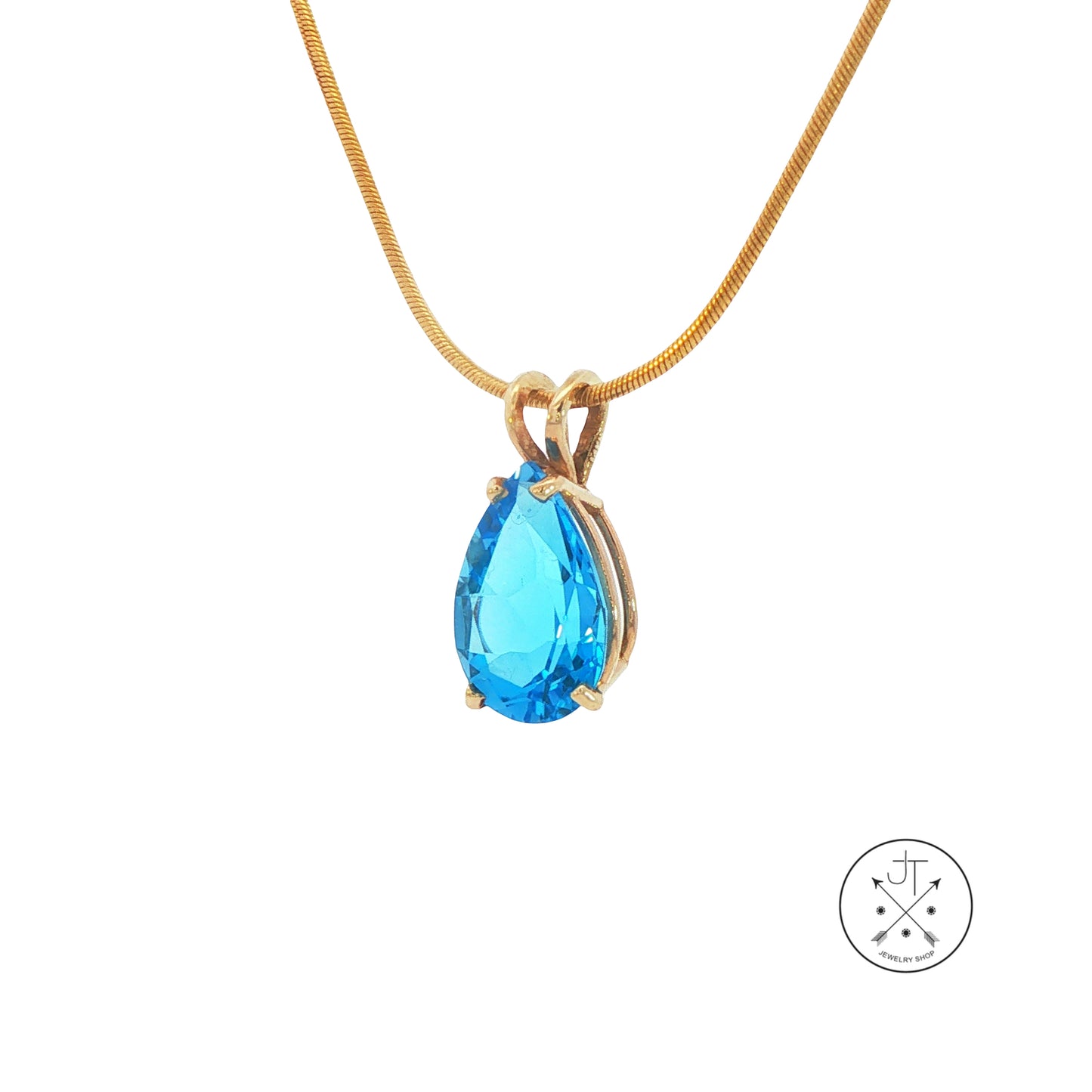 Gold necklace with a blue teardrop pendant on a white background