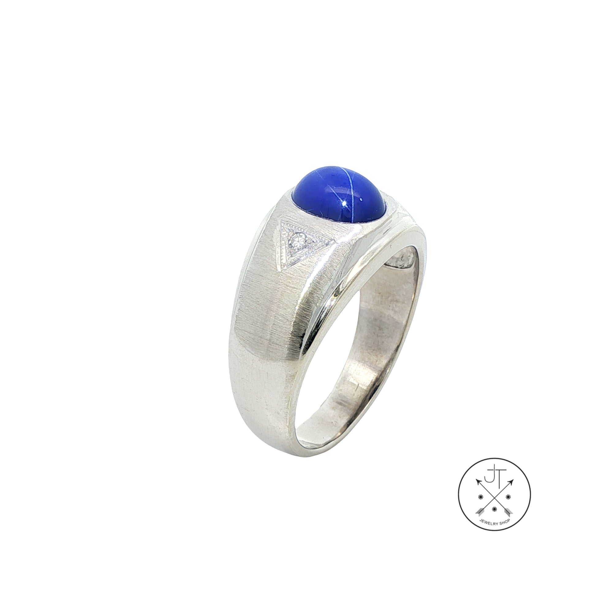 White Gold ring with a blue star sapphire cabochon on a white background