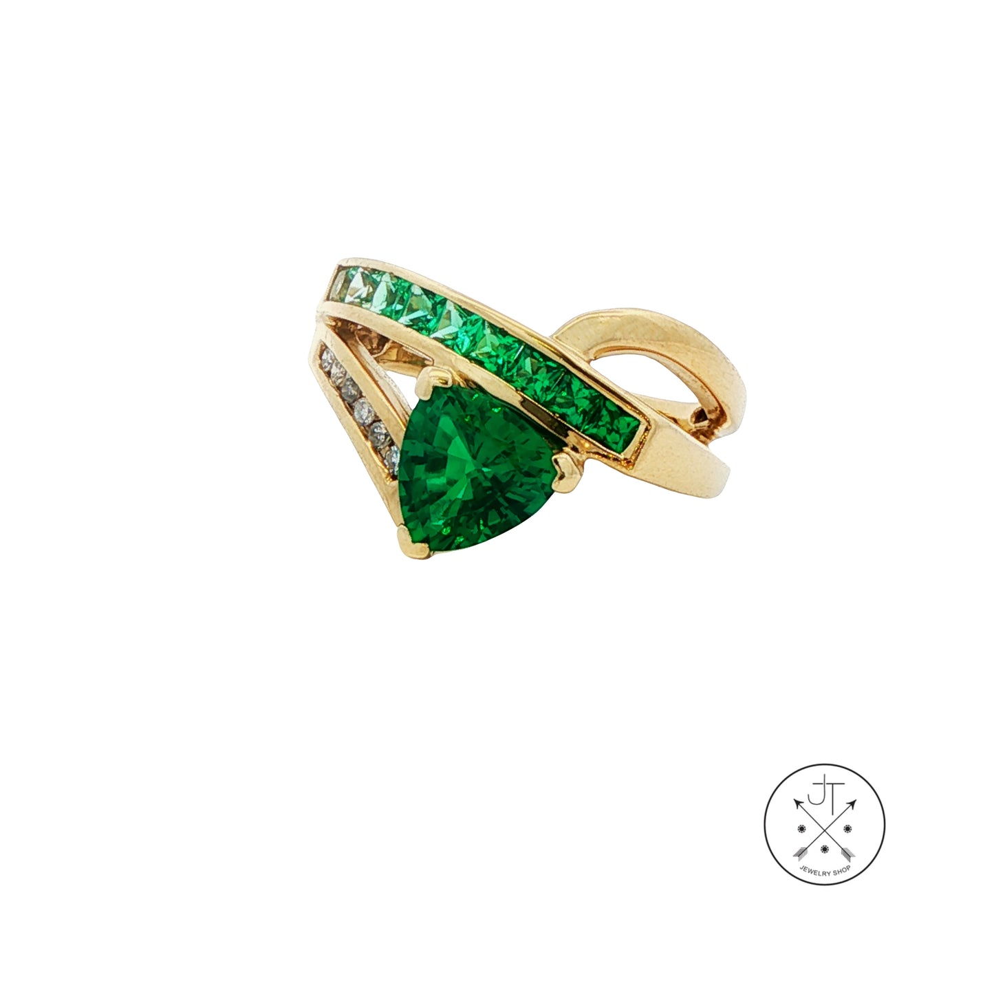 Gold ring with green gemstone on a white background