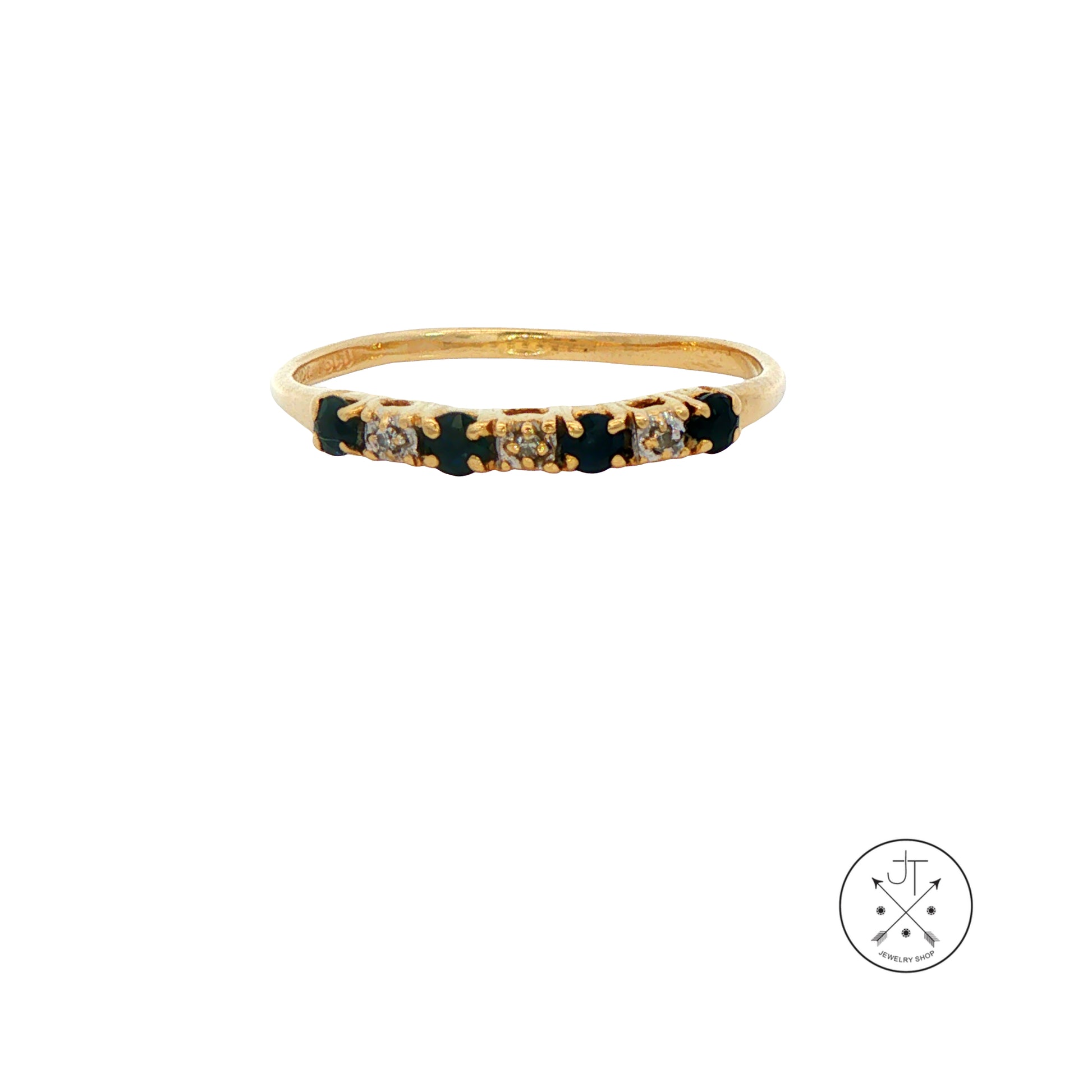 Gold ring with embedded stones on a white background