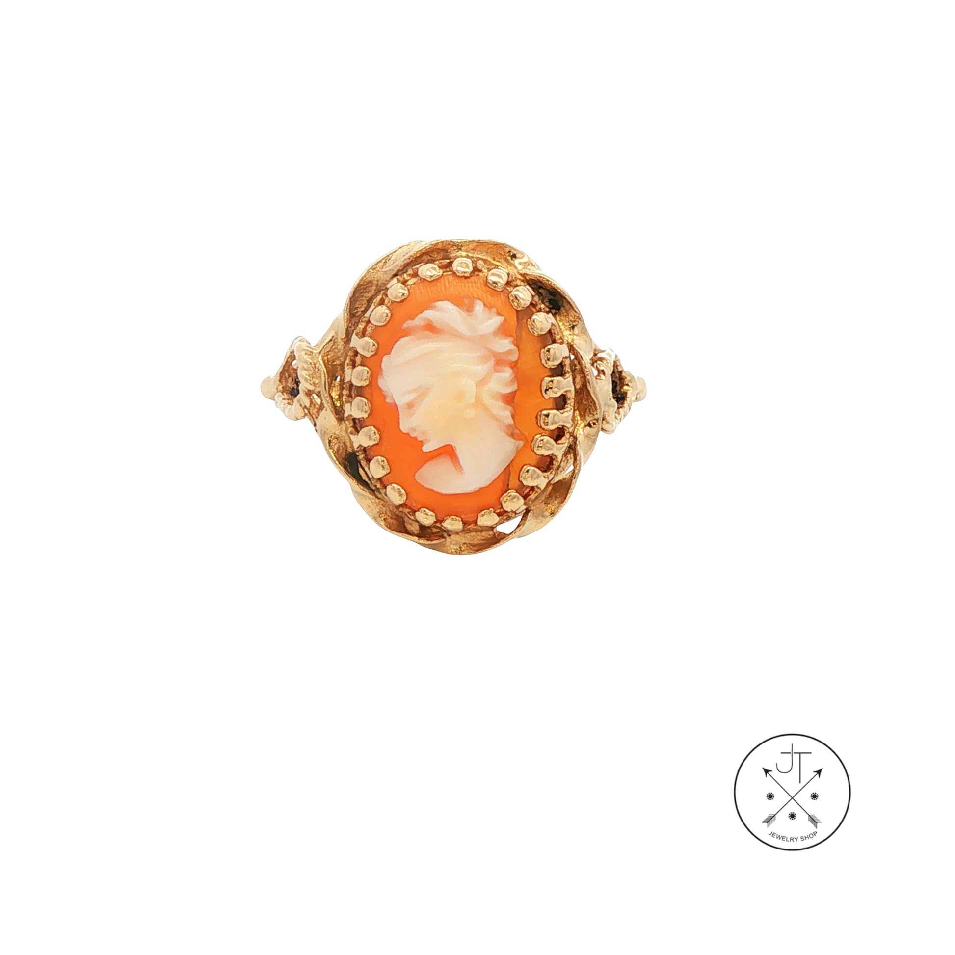 Gold ring with a cameo design on a white background