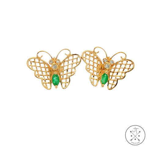 Gold butterfly earrings with green gemstones on a white background