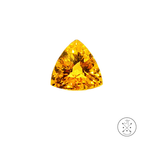 A single triangular golden beryl on a plain white background with a small circular logo in the bottom right corner.