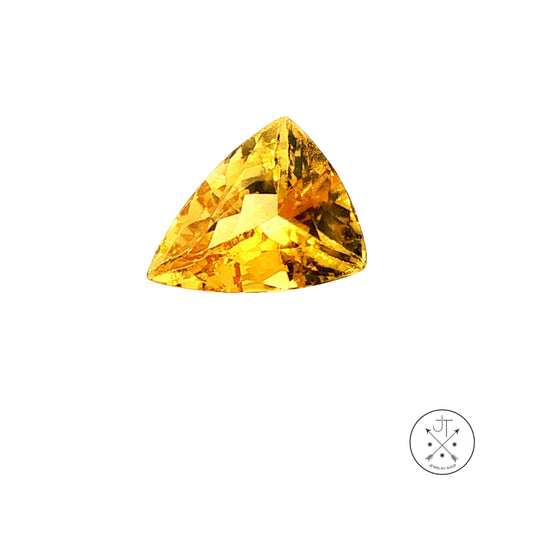 A single triangular golden beryl on a plain white background with a small circular logo in the bottom right corner.