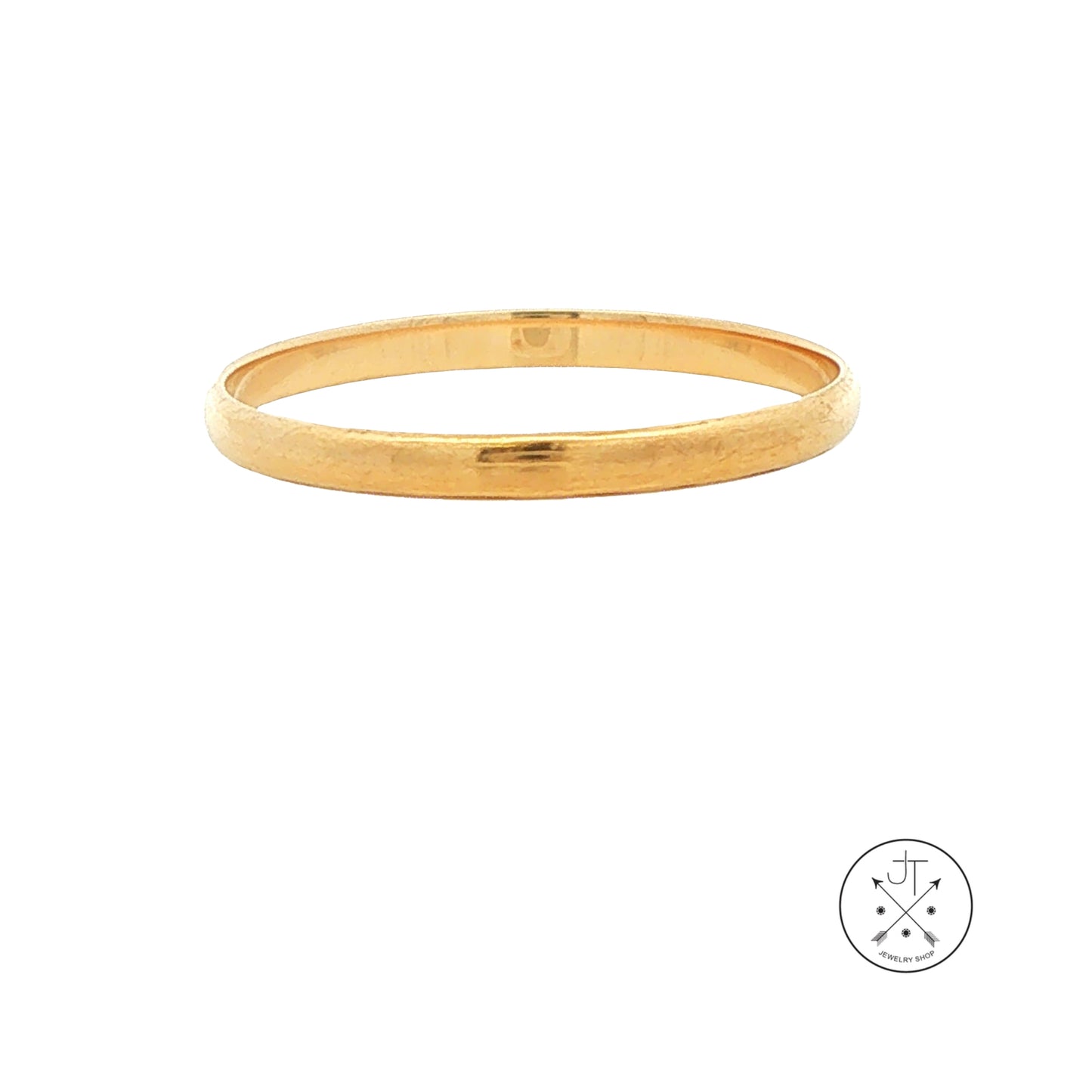 A thin, polished gold wedding band shown against a plain white background, with a small circular logo in the bottom right corner.
