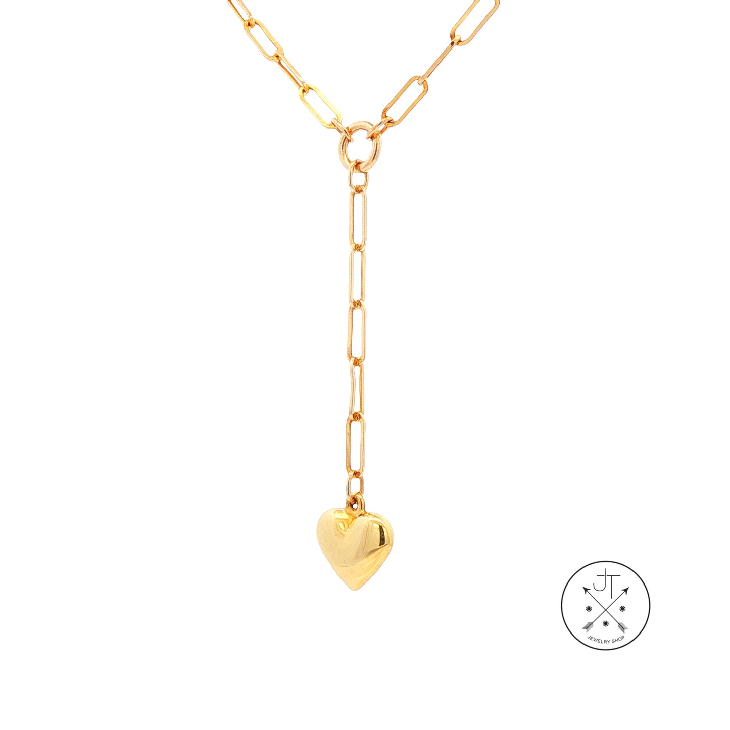 A gold paperclip chain necklace with a Y-shaped drop and a small heart pendant, shown on a plain white background with a circular brand logo in the bottom right corner.