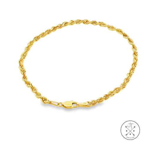 A yellow gold rope chain bracelet with a lobster clasp, displayed on a clean white background with a small circular logo in the bottom right corner.
