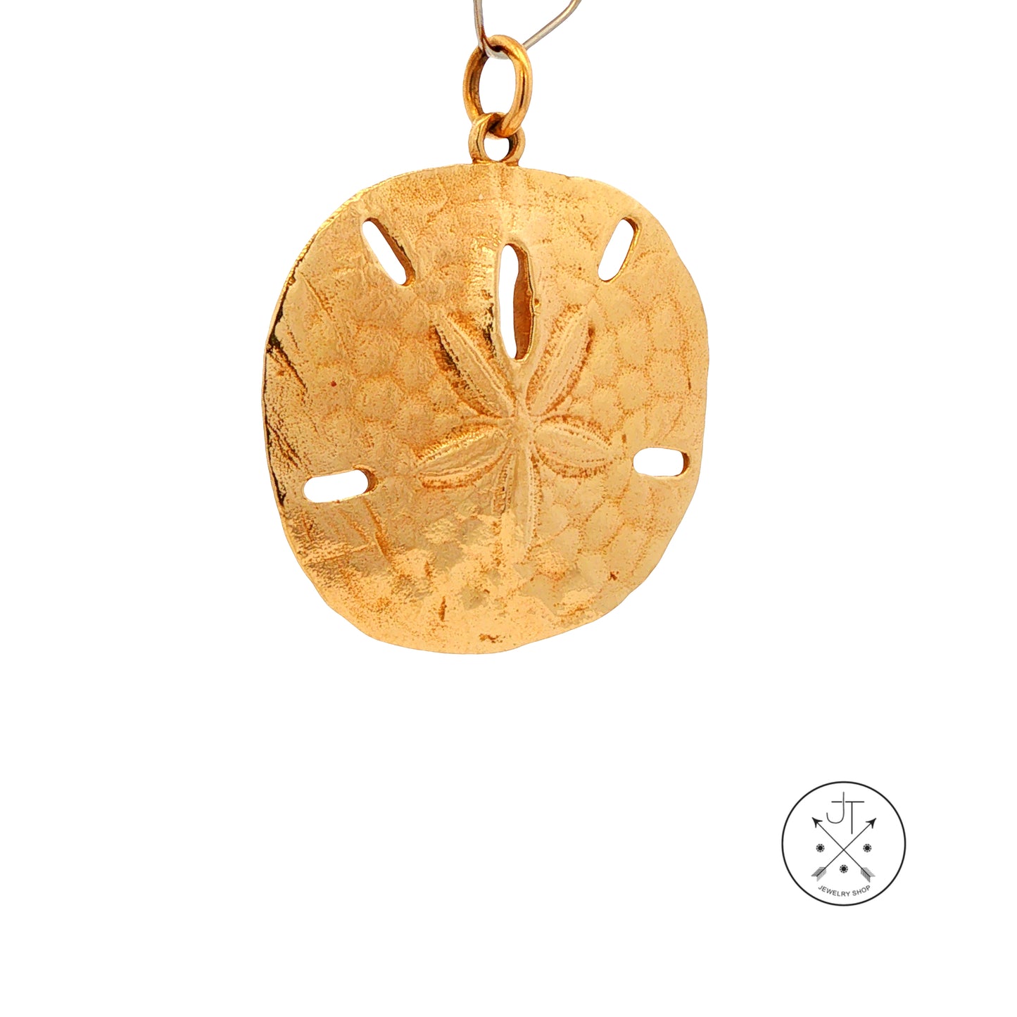 A yellow gold sand dollar pendant with a textured, embossed design and cutouts, shown on a white background with a small circular logo in the bottom right corner.