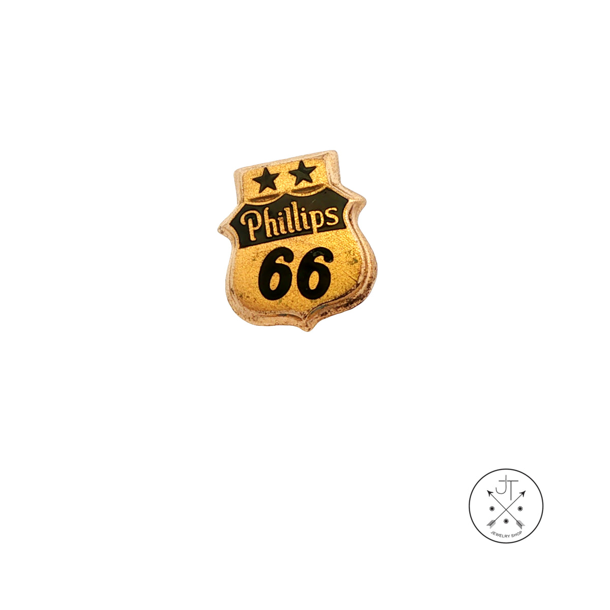 A small shield-shaped pin with the words 'Philips 66' in black on a gold-toned background, centered on a plain white background. A small circular logo appears in the bottom-right corner.