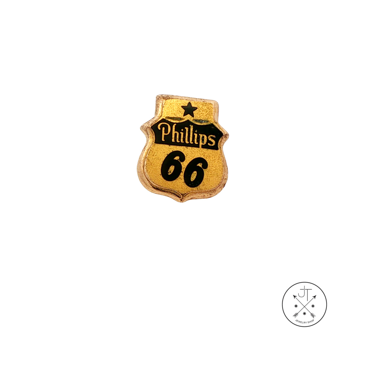 A small shield-shaped gold pin with black lettering reading 'Phillips 66' and a black star, shown on a plain white background. A small circular watermark appears in the lower right corner.