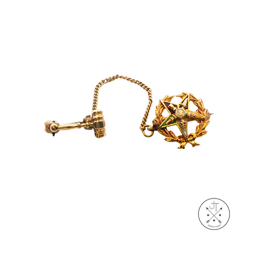 A vintage gold tie clip with a star and laurel wreath pendant, shown from both front and back views on a white background.