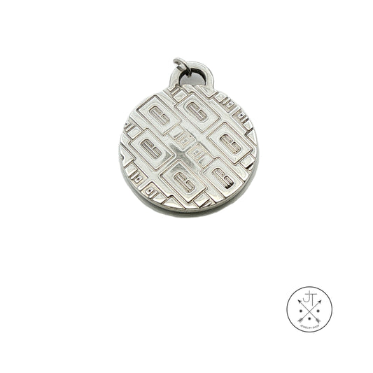 A round sterling silver pendant featuring a detailed geometric pattern, shown on a clean white background with a small brand logo in the bottom right corner.